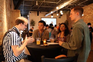 Four people at a table talking