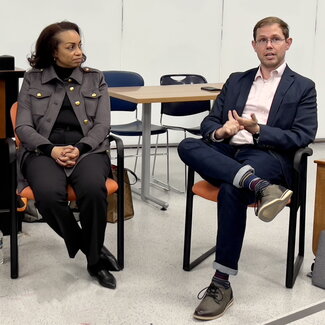 Brett (seated in chair) answers a panel question while LaShaunda (also seated) listens.