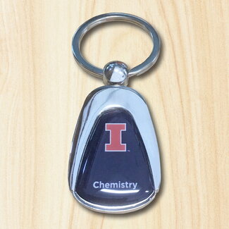 Silver keychain with blue insert printed with an orange & white block "I" and the word chemistry, in white.