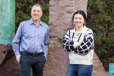 Photo of Andrew Gewirth in a blue button-down shirt standing next to graduate student Stephanie Chen in an outdoor photo on the UIUC campus 