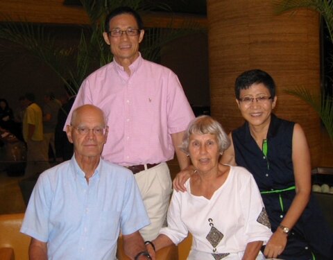 A photo of Peter Beak sitting next to his wife, Sandy Beak, with Alumnus Dr. Dekai Loo and his wife, JianJian, standing behind the Beaks at an event in Hong Kong in 2013. 