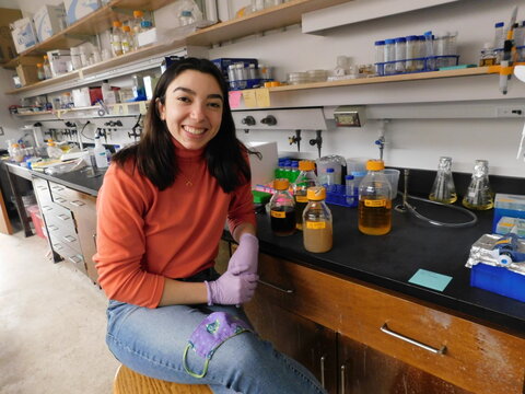 Marya sitting at a work bench in a chemistry lab