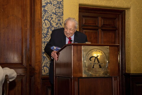 Photo of Rudy Marcus at a podium speaking