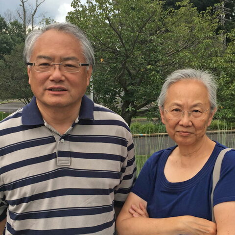 Outdoor portrait of Ving and May Lee standing side by side