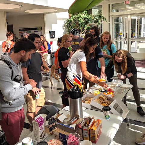 Students enjoying a coffee break event are pictured in the CLSL atrium on UIUC campus.