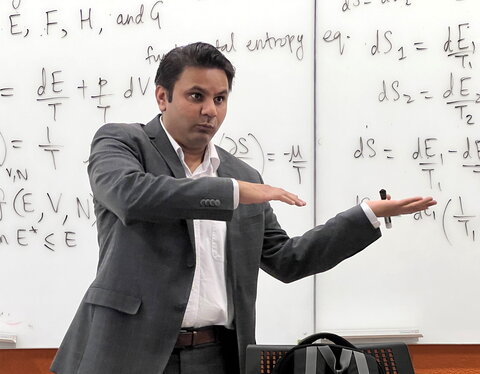 Prashant Jain teaches class standing in front of a wipe off board.