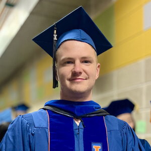 Head shot of Casey Olen in graduation cap and gown