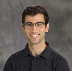 Head shot of Blake Levy on a dark gray background