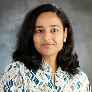 Head shot of Sonam Rani on a gray background