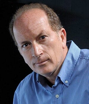 Head shot of Alejandro Ibarra on a black background