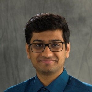Head shot of Omkar Chaudhari on a gray background