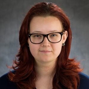 Head shot of Rowan Glover on a gray background