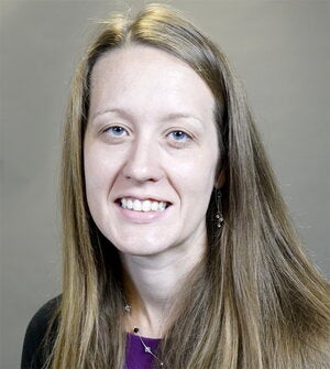 Head shot of Elise McCarren on a gray background
