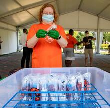 Volunteer works at a COVID-19 testing site on campus