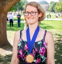 Kelsie Green stands near a tree on the UIUC quad with the Presidential Medallion around her neck.