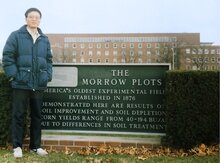 Photo of Chuanjing Xu in front of the sing for the Morrow Plots - America's oldest experiment field extablished in 1876.