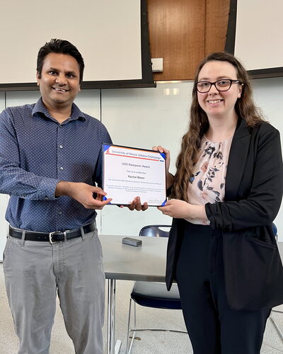 Two people standing holding a certificate