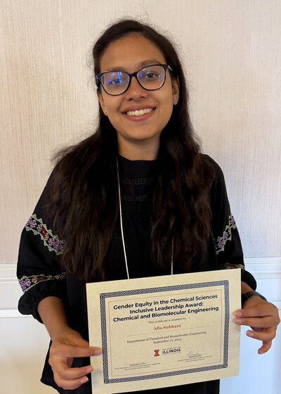 Portrait of Afia Subhani holding a certificate