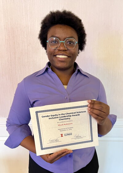 Portrait of Micah Robinson holding a certificate