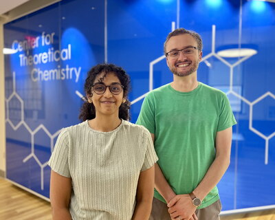 Shruti Iyer and Nick Jackson stand side by side in front of a blue wall