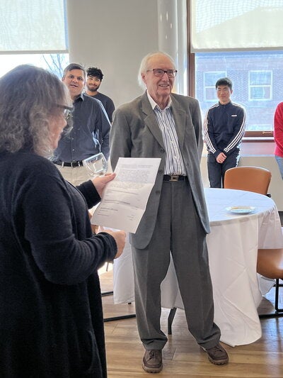 Eric Oldfield standing next to a table at a reception.