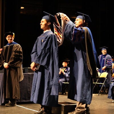 Professor Don DeCoste hooding Ethan Ramirez at Convocation.