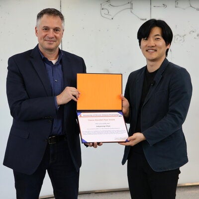 Liviu Miric and Jubyeong Chae stand together holding TS Piper Award.