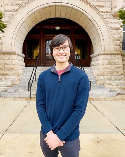 Portrait of Gavin Hazen in front of arch entrance