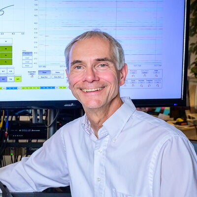 Martin Gruebel sitting in front of a large computer monitor