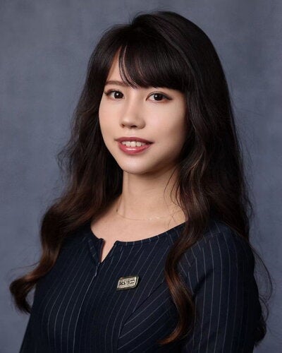 Portrait of Kerry Xu on a dark gray background