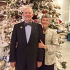 Photo of Bill Walters standing next to Barbara Walters with a holiday tree in the background.