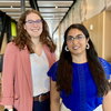 Portrait of Katherine Hatzis and Archana Verma standing side by side in building on campus