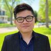 Head shot of Dinh Nguyen in an outdoor setting with a street, tree and house in the background