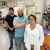 Lisa Olshansky, Peter Thompson, and Carlos Nava stand side by side in a lab where they did research. 