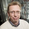 Head shot of Wilfred van der Donk in a lab in front of equipment