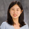 Head shot of Dong Ok Kim on a gray background.