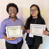 Picture of two people standing side by side holding award certificates