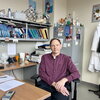 Don DeCoste sitting at a desk in his office