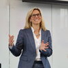 Stephanie Potisek Lee standing at the front of a classroom talking
