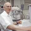 Richard Millberg sitting at a computer keyboard in a lab