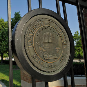 University of Illinois Learning & Labor seal on the gate in front of the Beckman Institute