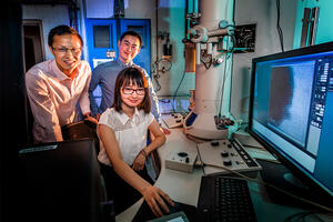 Professor Qian Chen, seated, and graduate students Binbin Luo, left, and Zihao Ou 
