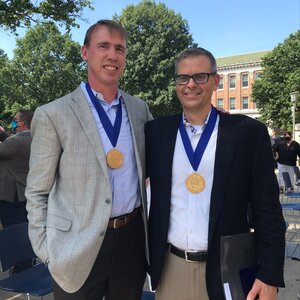 Paul Hergenrother and Martin Burke standing side by side with Presidential Medallions around their necks on the Quad outside Illini Union.