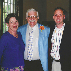An indoor photo of Becky Simon, left, standing next to Steven Zumdahl, and Dan Hanus with a large window in the background.