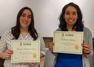 Joenisse Rosado-Rosa and Catherine Jalomo stand next to each other holding their Outstanding Mentoring certificates.