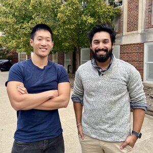 Portrait of graduate students Michael Lee and Rodrigo Tapia Hernandez standing side by side in front of Roger Adams Laboratory. 