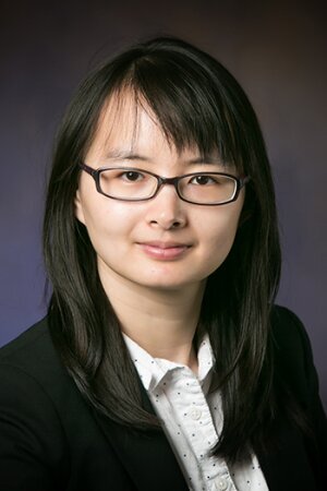 Portrait of Qian Chen on a dark background