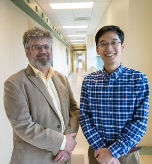 Jonathan Sweedler stands next to Fan Lam in a hallway on the Illinois campus.
