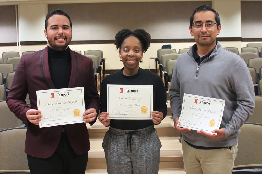 Photo of three students holding certificates