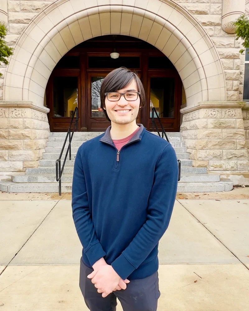 Portrait of Gavin Hazen in front of arch entrance